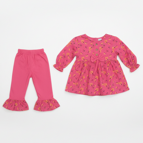 Pink floral baby outfit on white wall