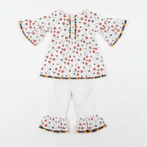 White floral baby outfit with rainbow pom-pom trim